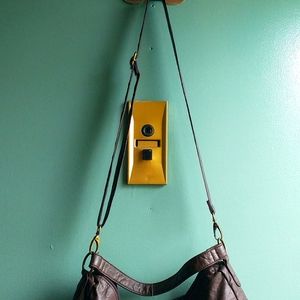 Crossbody or carry never been used wt 2 big zipper pockets with two snap brown